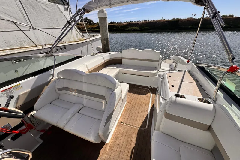 2012 Formula 290 Sun Sport boat interior with white seating and wood flooring.