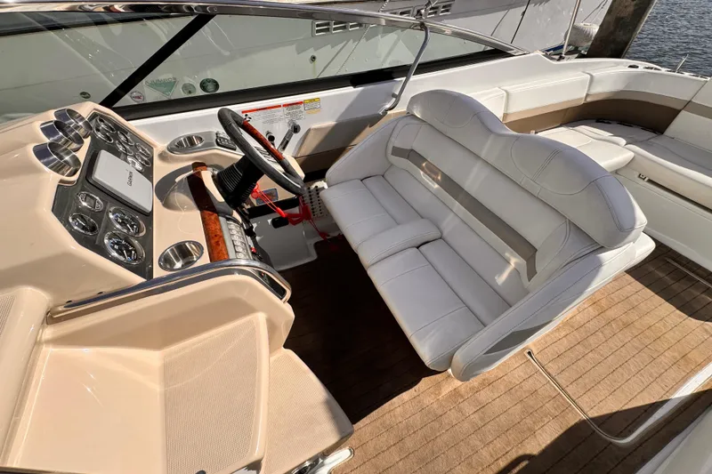 2012 Formula 290 Sun Sport boat interior with steering wheel and white seating.