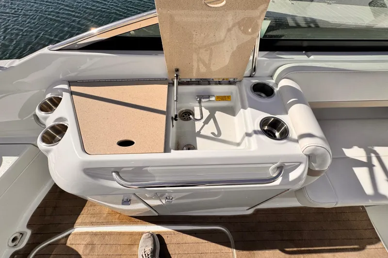 2012 Formula 290 Sun Sport boat interior with sink and cup holders.