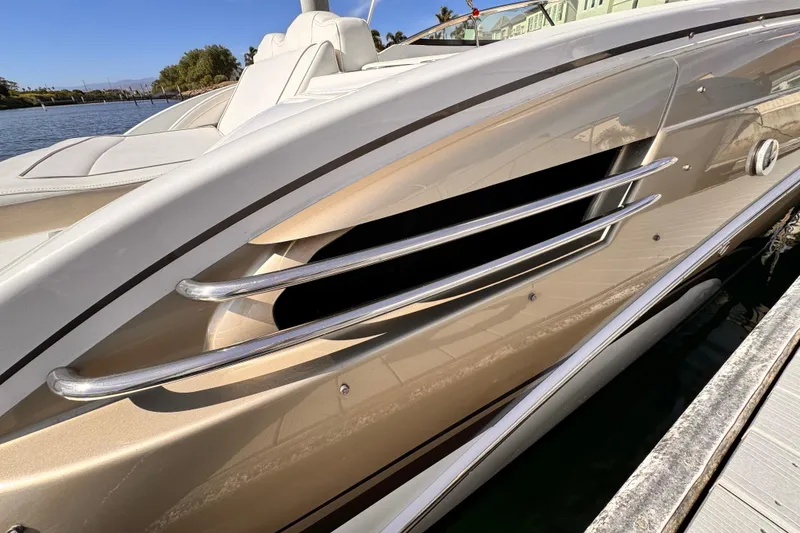2012 Formula 290 Sun Sport boat side view with sleek metallic design and chrome accents.