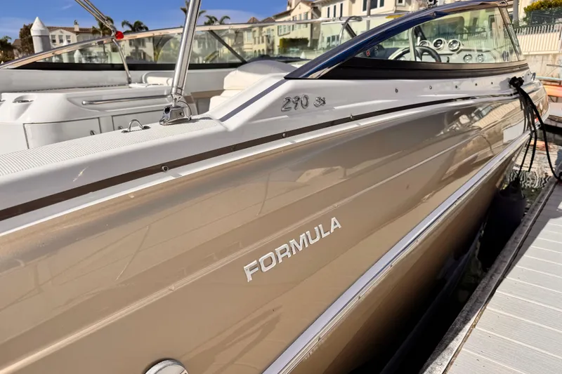 2012 Formula 290 Sun Sport boat docked, showcasing sleek design and branding.