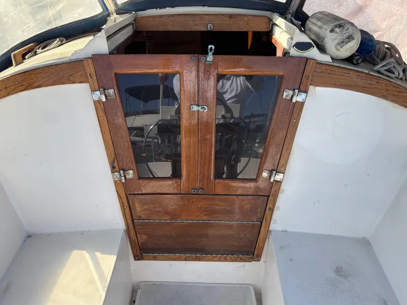 Wooden hatch door on 1985 Newport 30 sailboat, cockpit view.