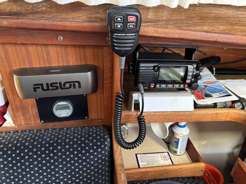Interior of a 1985 Newport 30 sailboat with radio equipment and Fusion stereo system.