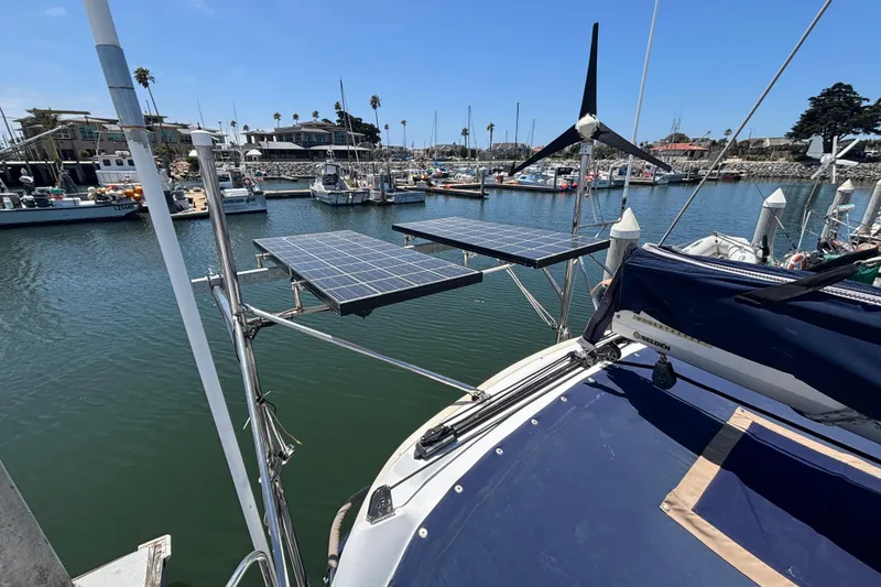 Sailboat with solar panels and wind turbine in marina, Hunter 410, 1999 model.