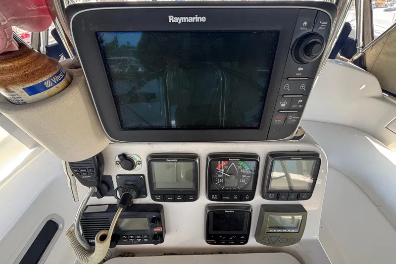 Cockpit navigation instruments on a 1999 Hunter 410 sailboat, featuring Raymarine displays.