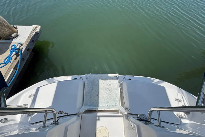 Stern view of 1999 Hunter 410 boat docked on calm water.