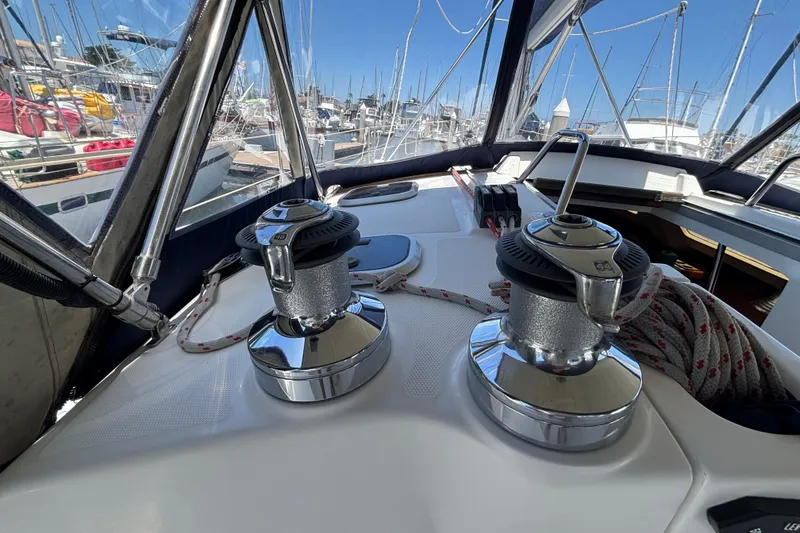 Hunter 410 sailboat deck with winches and ropes, docked in a marina, 1999 model.