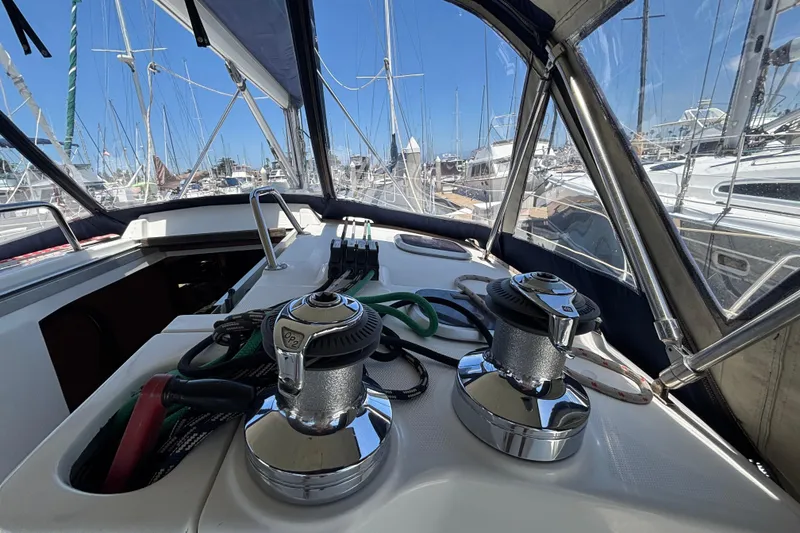 Cockpit view of a 1999 Hunter 410 sailboat with winches and ropes.