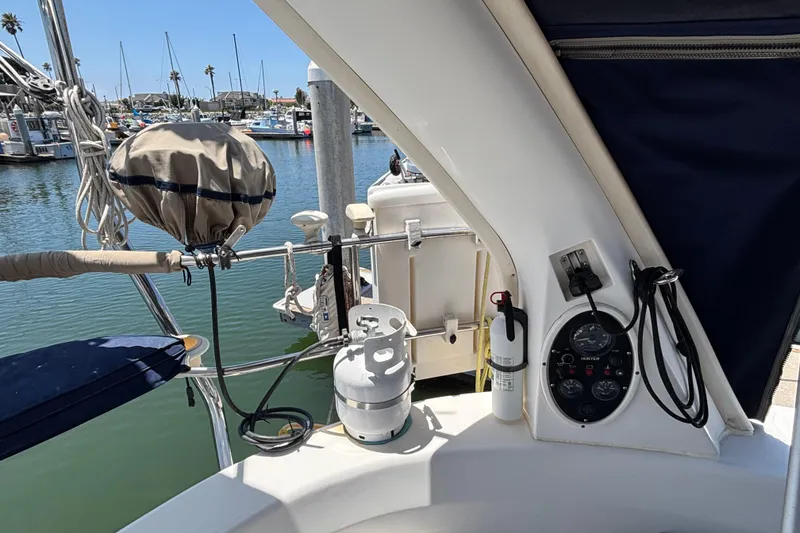 Cockpit of a 1999 Hunter 410 sailboat with control panel and safety equipment.