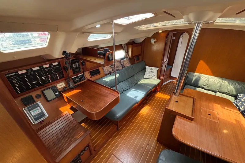 Interior of a 1999 Hunter 410 sailboat with wood finish and navigation equipment.