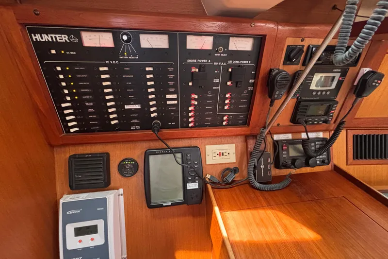 Control panel of a 1999 Hunter 410 sailboat with navigation and communication equipment.