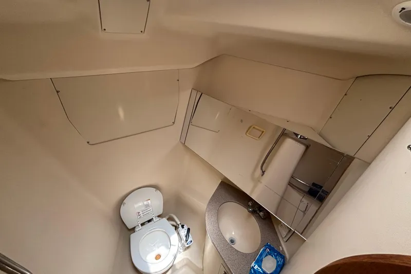 Bathroom interior of a 1999 Hunter 410 yacht, featuring a toilet and sink.