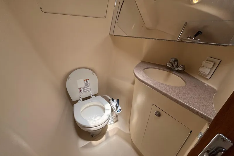 1999 Hunter 410 yacht bathroom with toilet, sink, and mirror.