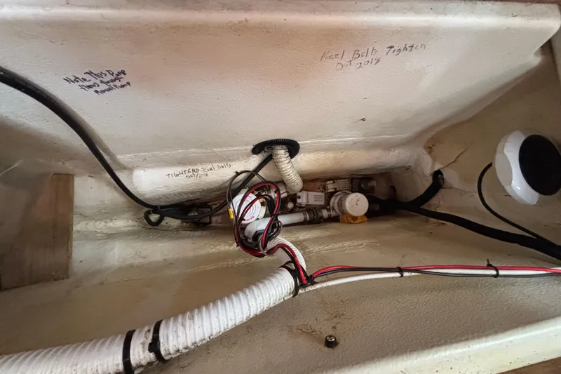 Interior view of a 1999 Hunter 410 sailboat showing wiring and keel bolt notes.