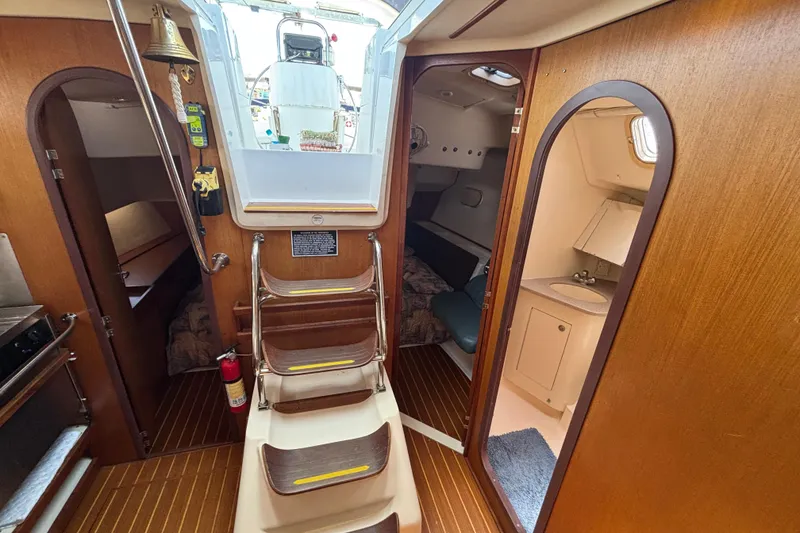 Interior of 1999 Hunter 410 sailboat with wooden finish and compact living space.