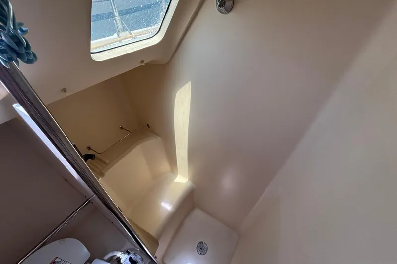 Interior of a 1999 Hunter 410 sailboat bathroom with shower and skylight.