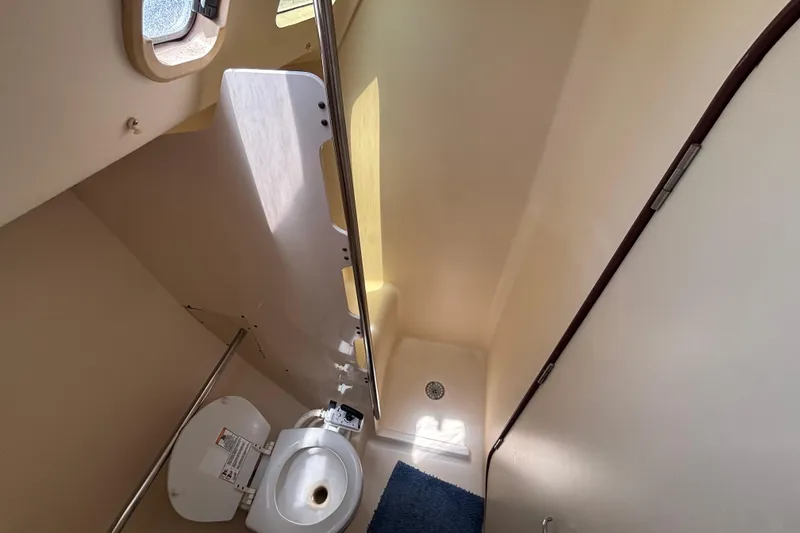 Bathroom interior of 1999 Hunter 410 yacht, featuring toilet and shower area.