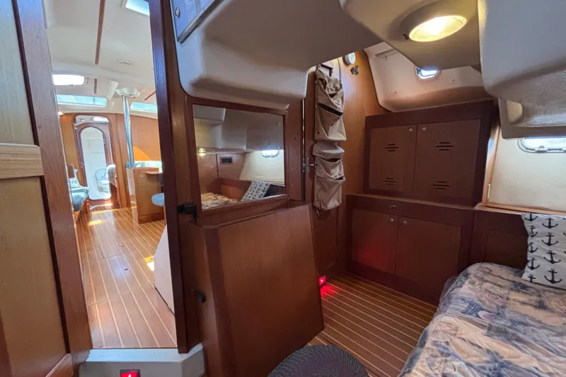 Interior of a 1999 Hunter 410 sailboat with wood finish and cozy cabin layout.