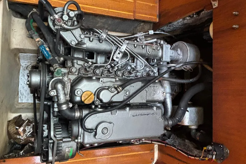 Engine of a 1999 Hunter 410 sailboat, showcasing mechanical components and hoses.