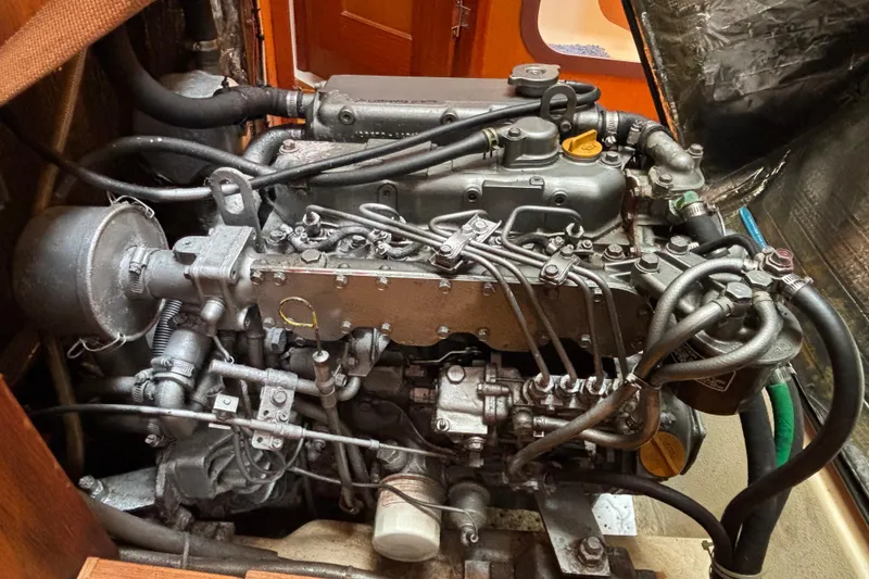 Engine of a 1999 Hunter 410 sailboat, showcasing intricate mechanical components.