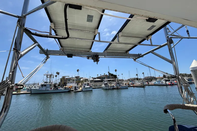 View from a 1999 Hunter 410 sailboat overlooking a marina with docked boats.