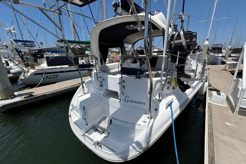 Hunter 410 sailboat from 1999 docked at a marina, rear view.