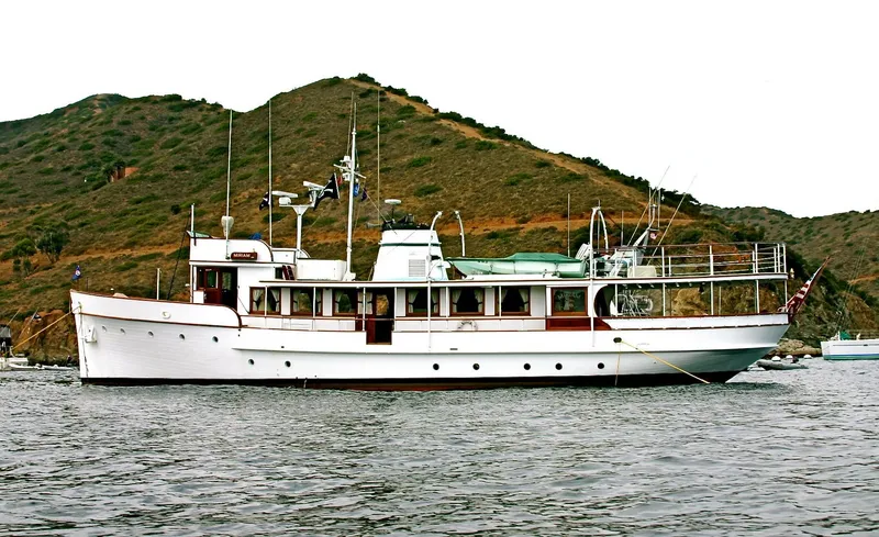 Classic 1946 J.M. Martinac motor yacht near an island.