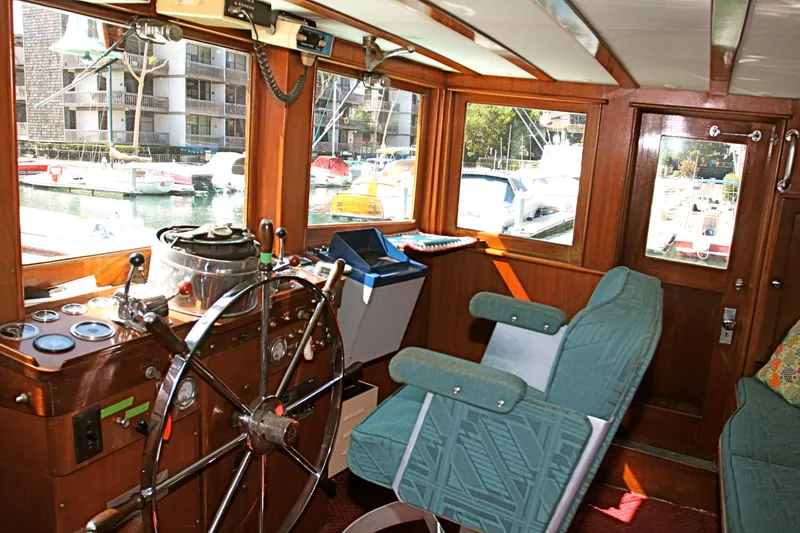 Interior of a 1946 J.M. Martinac classic yacht with steering wheel.