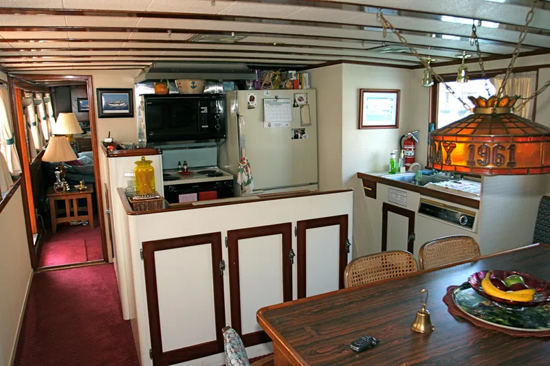 Interior of a classic yacht kitchen with wood details, built in 1946.
