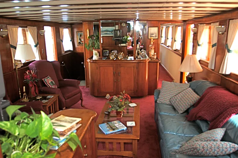 Interior of a classic yacht with wooden furniture and cozy decor.