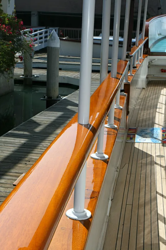 Polished wooden railing on a 1946 classic yacht.