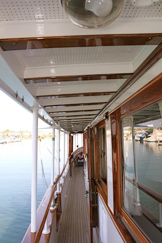 Walkway on a classic yacht with wooden accents, built in 1946.