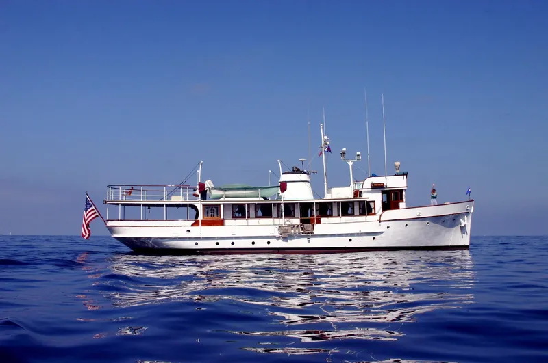 Classic 1946 J.M. Martinac motor yacht on calm sea.