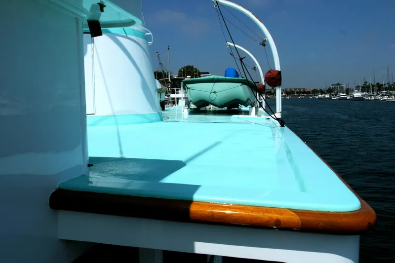 1946 J.M. Martinac yacht with turquoise deck in harbor.