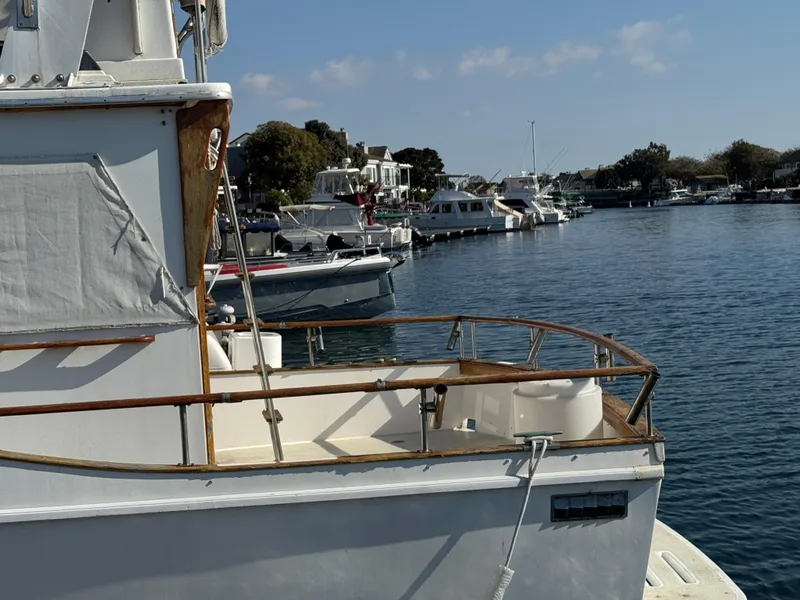 1979 Californian LRC Sedan Bridge docked in a marina with other boats.
