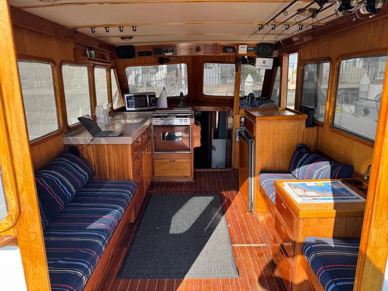 Interior of a 1979 Californian LRC Sedan Bridge with wood paneling and striped seating.