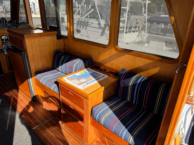 Interior of 1979 Californian LRC Sedan Bridge with striped seating and wooden furnishings.