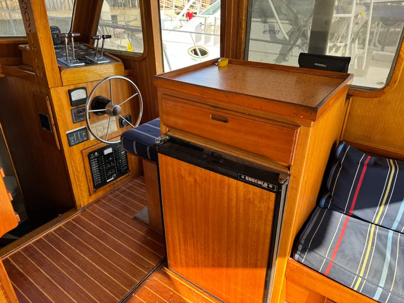 1979 Californian LRC Sedan Bridge interior with wooden helm, steering wheel, and seating area.