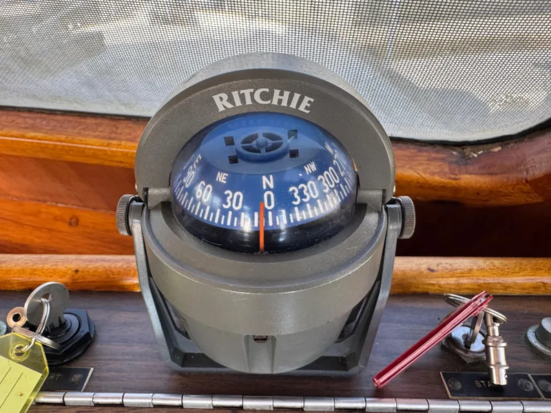 Compass on 1979 Californian LRC Sedan Bridge boat dashboard, showing north direction.