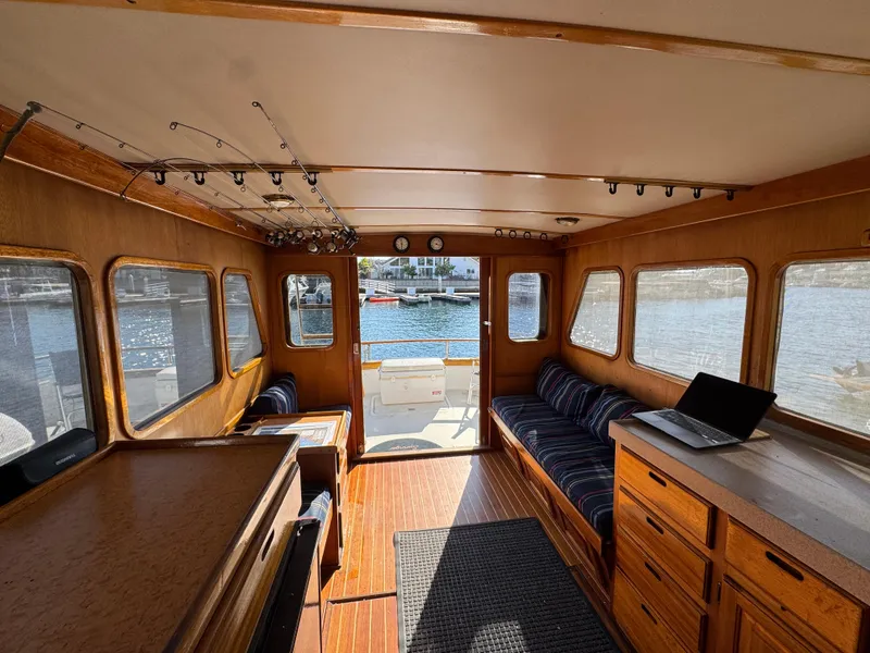 Interior of 1979 Californian LRC Sedan Bridge with wood finish and waterfront view.