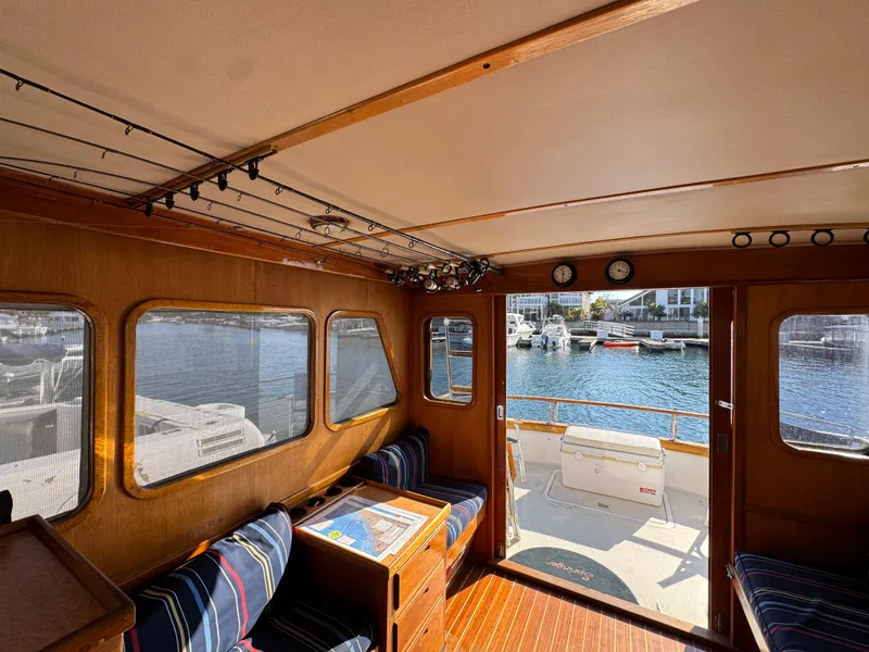 Interior of 1979 Californian LRC Sedan Bridge with wood paneling and marina view.