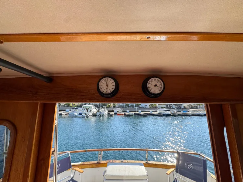 Interior view of 1979 Californian LRC Sedan Bridge overlooking marina with gauges.