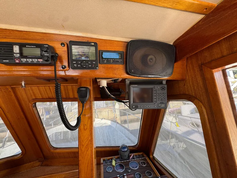 1979 Californian LRC Sedan Bridge helm with navigation equipment and wooden interior.