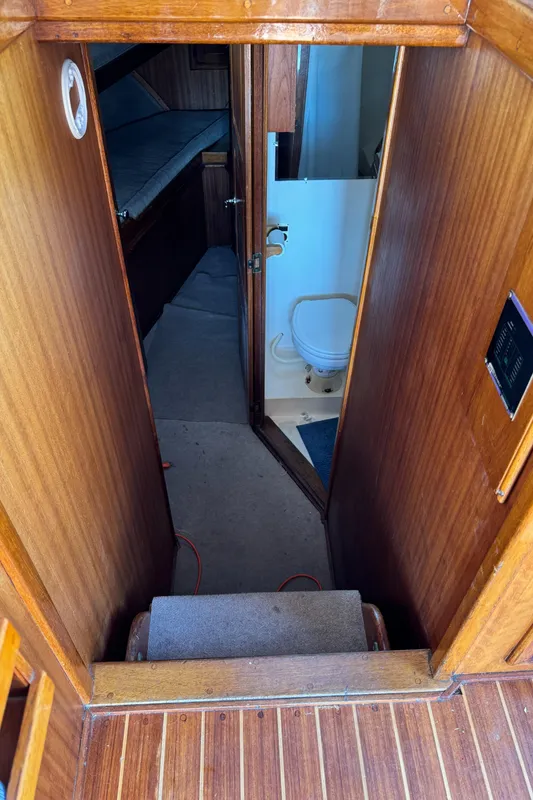 1979 Californian LRC Sedan Bridge interior with wooden paneling, showing a compact bathroom and cabin.