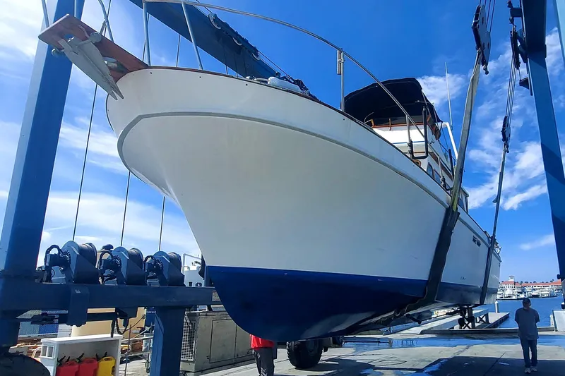 1979 Californian LRC Sedan Bridge yacht in dry dock, blue sky background.