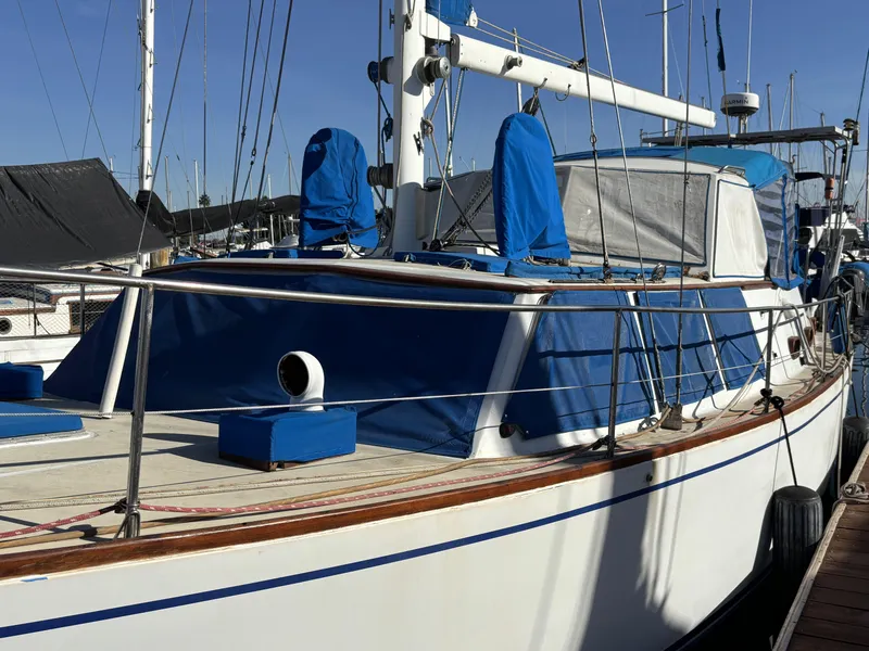 1973 CAL 246 sailboat docked, featuring blue covers and sleek design.