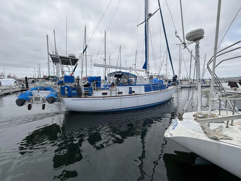 1973 CAL 246 sailboat docked in a marina, surrounded by other boats.