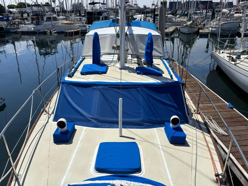 1973 CAL 246 sailboat docked in marina, featuring blue and white deck covers.