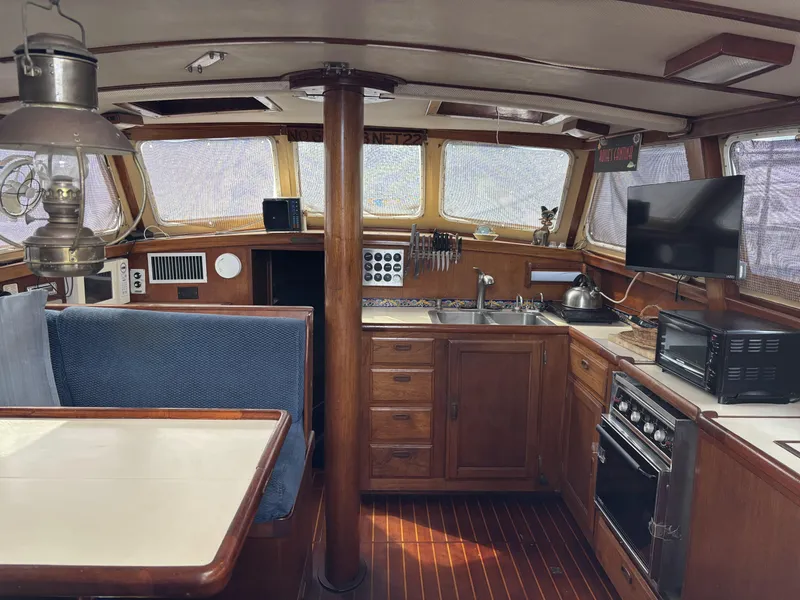 Interior of a 1973 CAL 246 sailboat with kitchen and dining area.