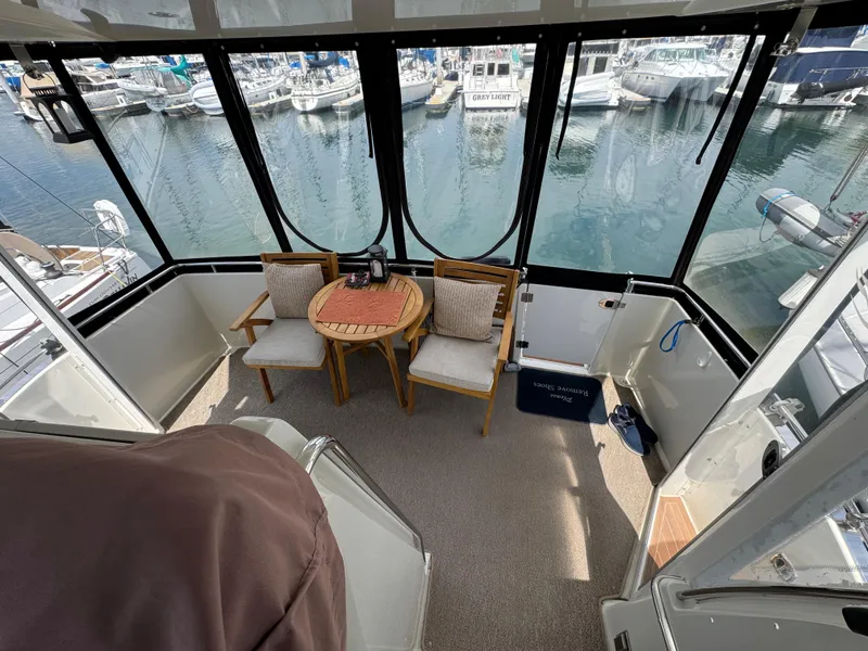 2004 Carver 366 Motor Yacht interior with seating area overlooking marina.